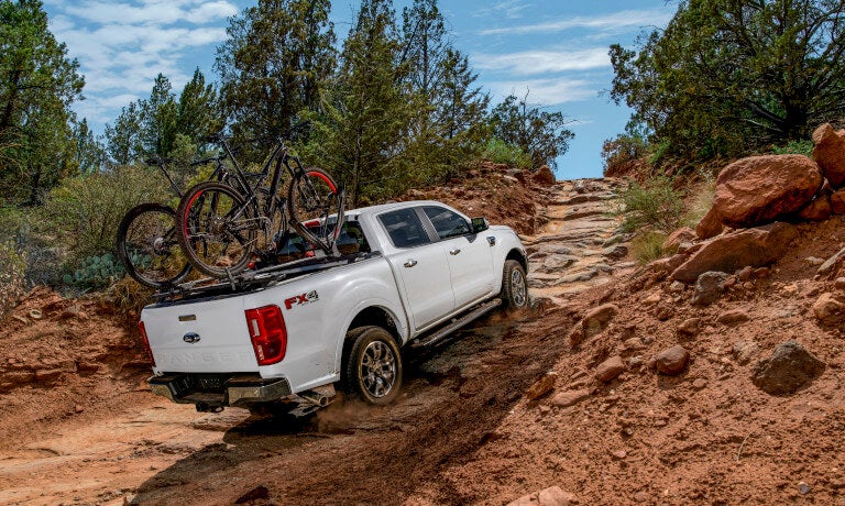 2023 Ford Ranger offroading rocky path with bikes