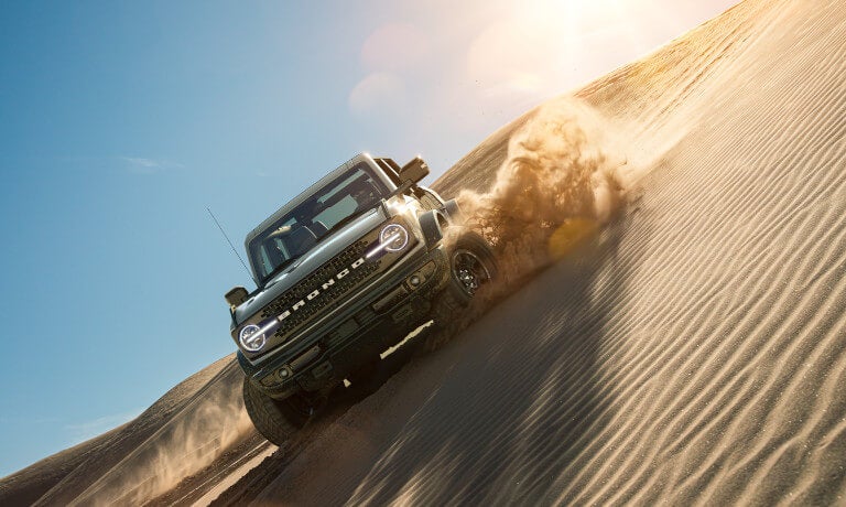 2025 Ford Bronco driving on a sand dune